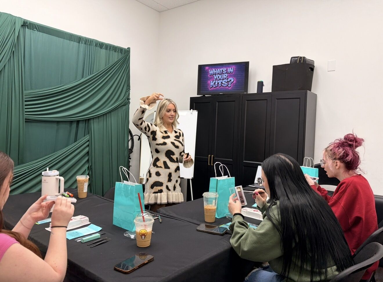 Cortney teaching a class of students at their lash stations
